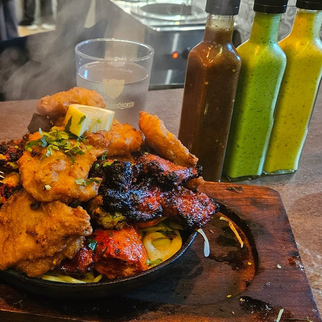 Smoking mixed grill sizzler with sauces and wine at Sheepscar Bar and Grill