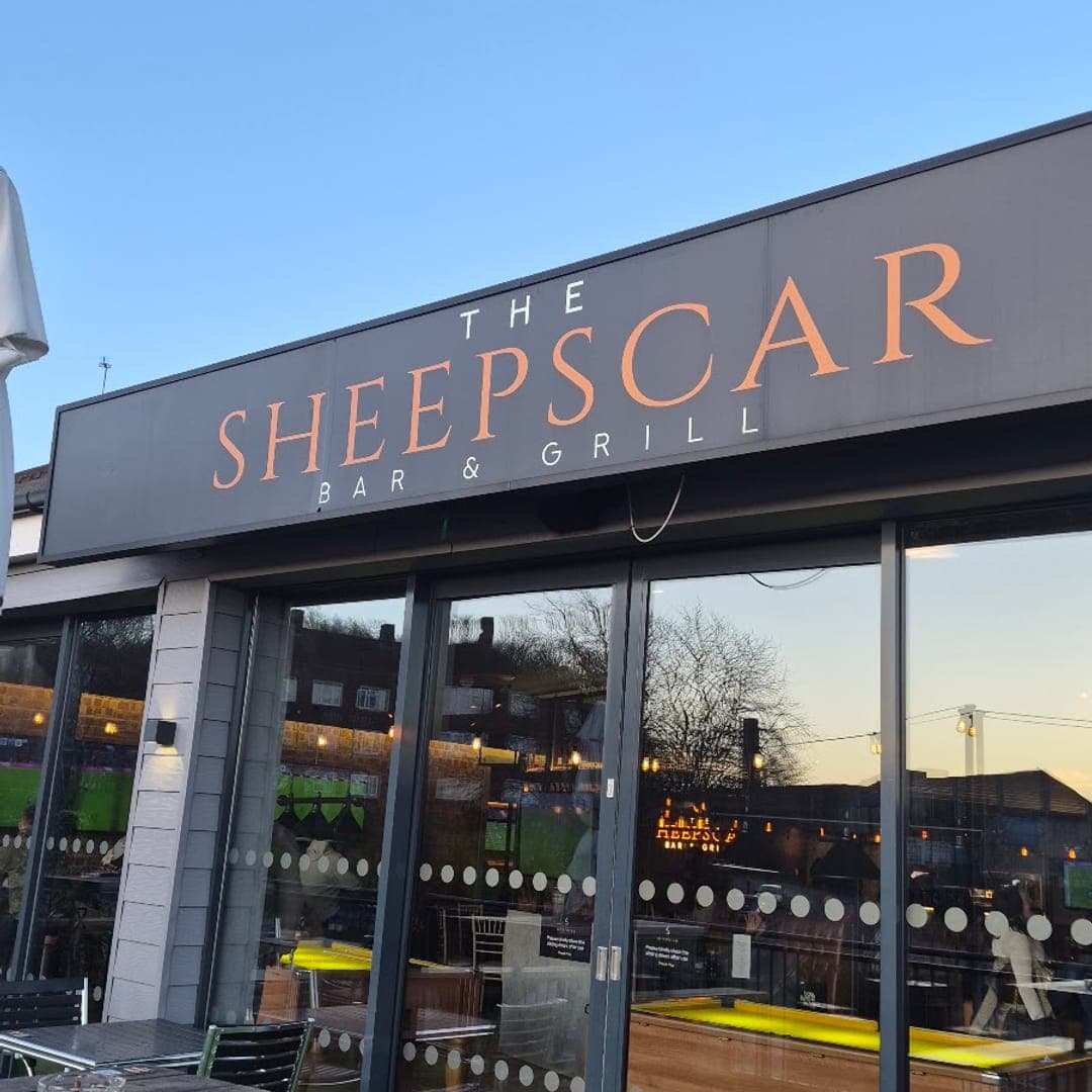 Exterior of The Sheepscar Bar and Grill with signage and outdoor area at dusk
