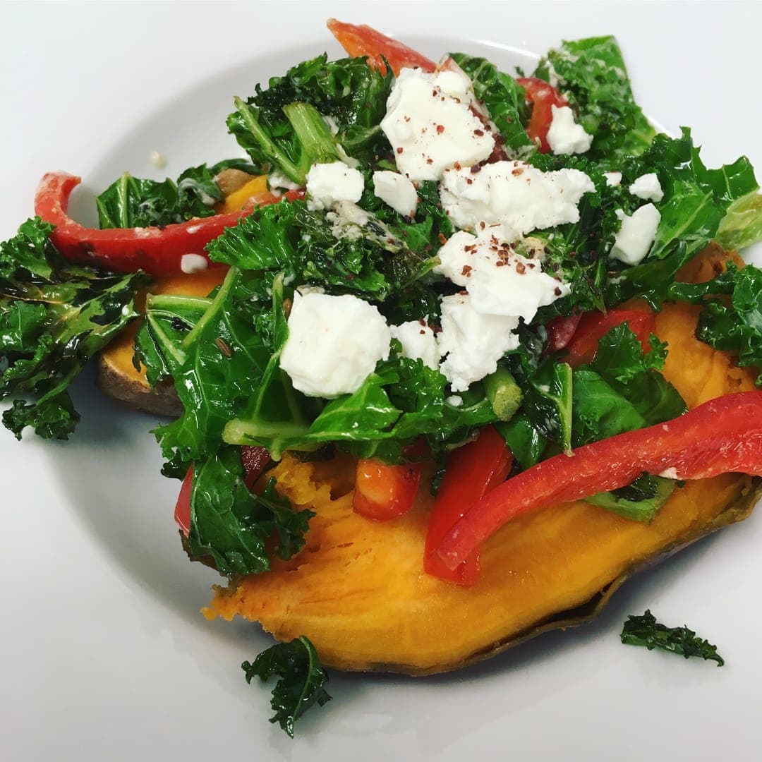 Roasted sweet potato topped with kale, feta, and red pepper at The Barn Coffee Shop