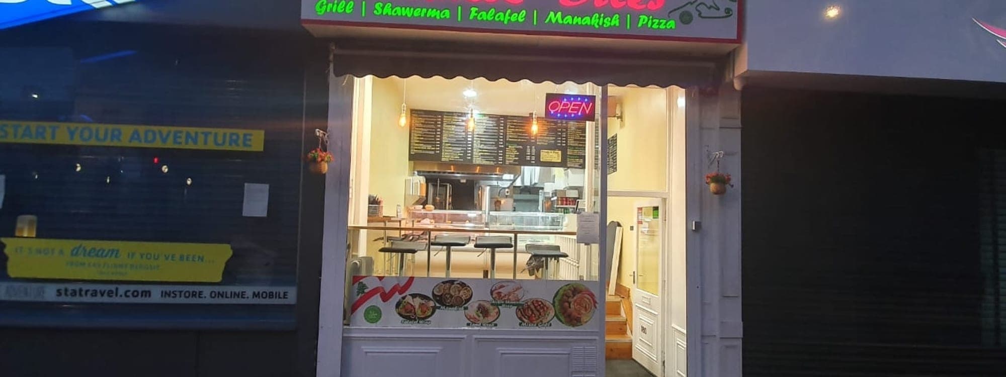 Lebanese Bites — exterior shopfront at night with neon open sign