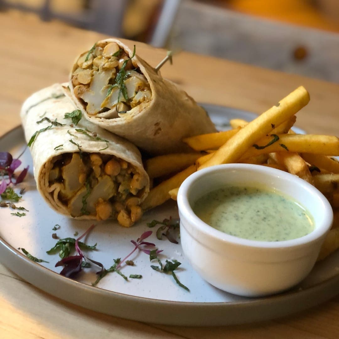 MISTÅL Kitchen — spiced chickpea wrap with fries and herb sauce