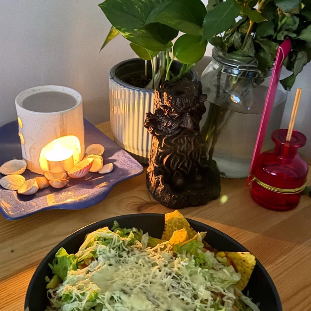 Munch Cafe English Kitchen — Caesar-style salad in a black bowl