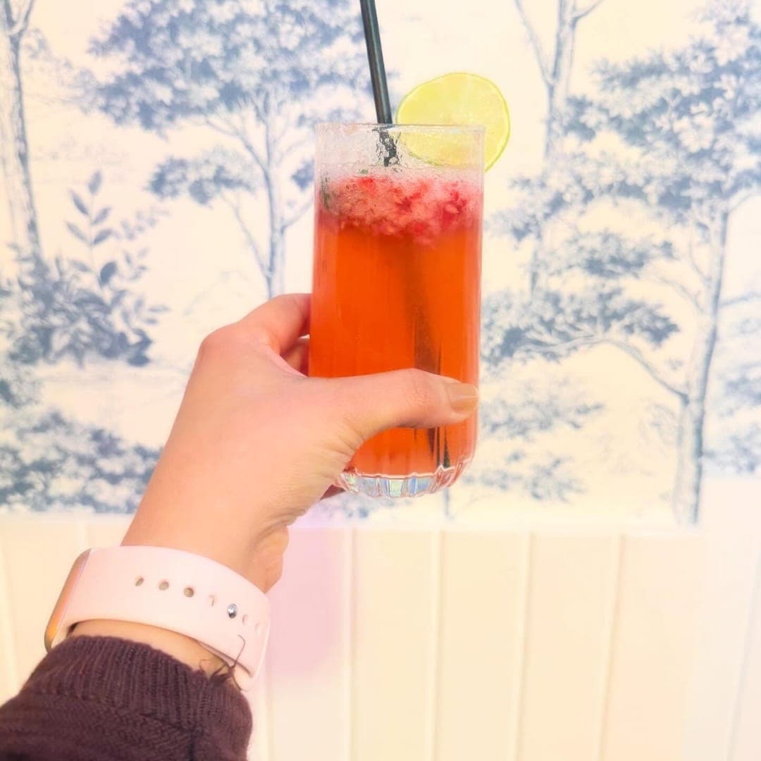 Munch Cafe English Kitchen — pink iced fruit drink with lime slice and straw