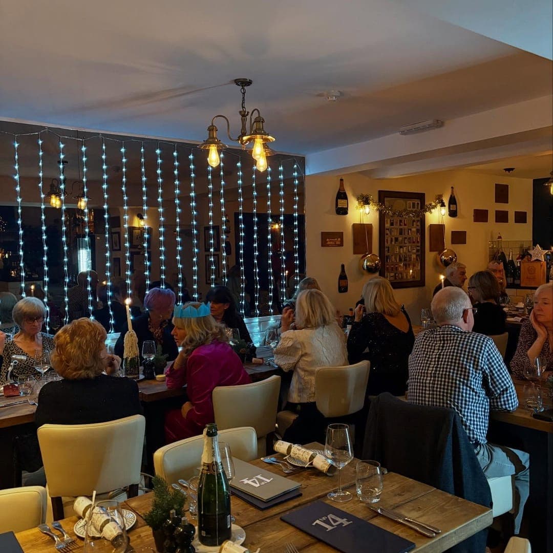 No 14 North Lane Restaurant & Bar — restaurant interior with guests dining and wine bottles on display