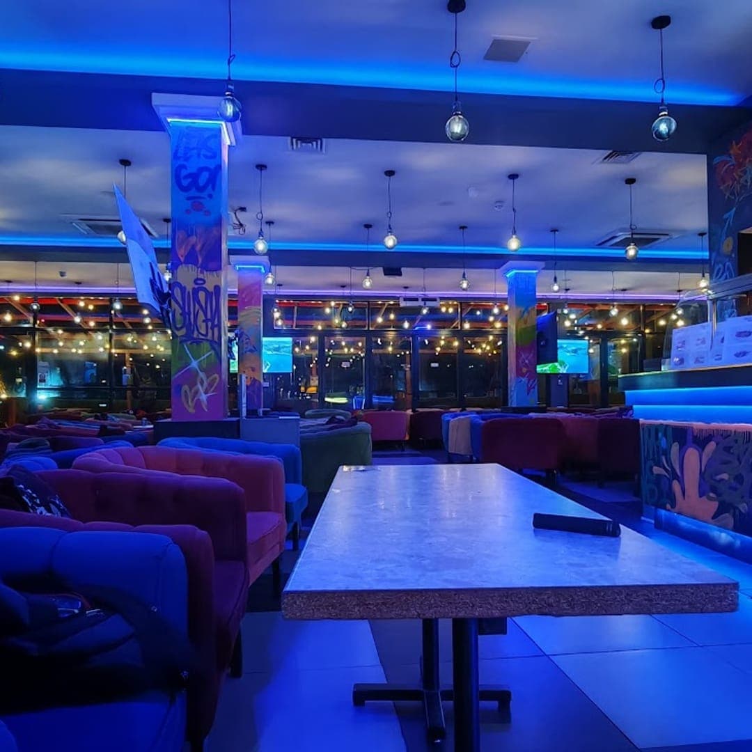 Panorama Garden — wide interior view with blue LED bar lighting and booth seating