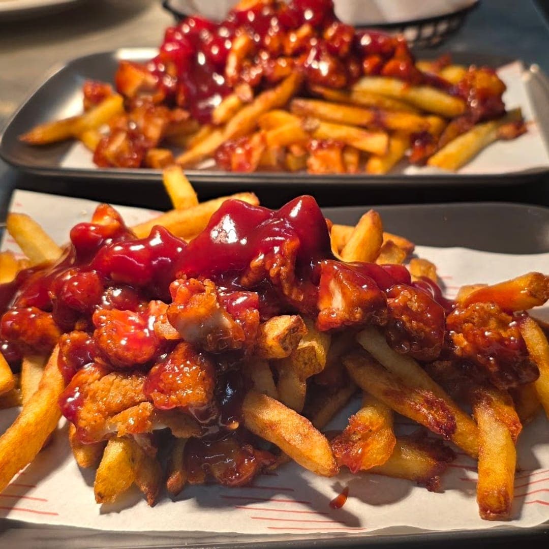 Panorama Garden — loaded fries with crispy chicken and chilli sauce on dark trays