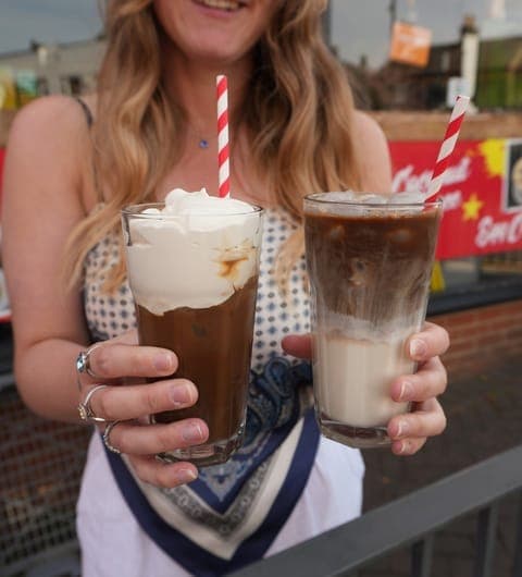 Pho 37 (Merrion Centre) — two layered Vietnamese iced coffees with red striped straws on a wooden table