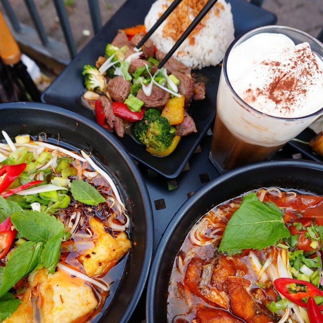 Pho 37 (Merrion Centre) — overhead spread of multiple Vietnamese dishes including hot pots and rice plates