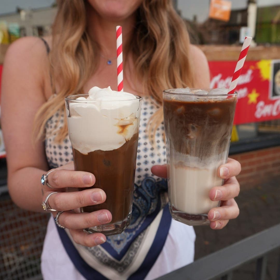 Pho 37 (Merrion Centre) — two Vietnamese iced coffees with cream and red striped straws on a wooden table