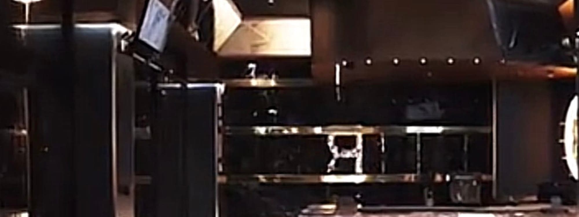 Riviera lounge — dark lounge interior with blue velvet seating and gold bar