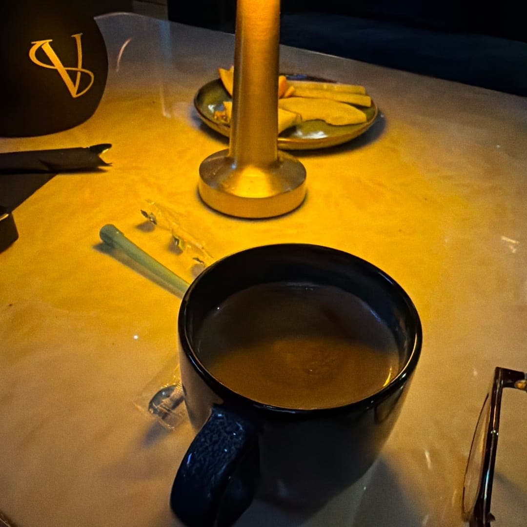 Riviera lounge — hot drink served on marble table with ambient lamp