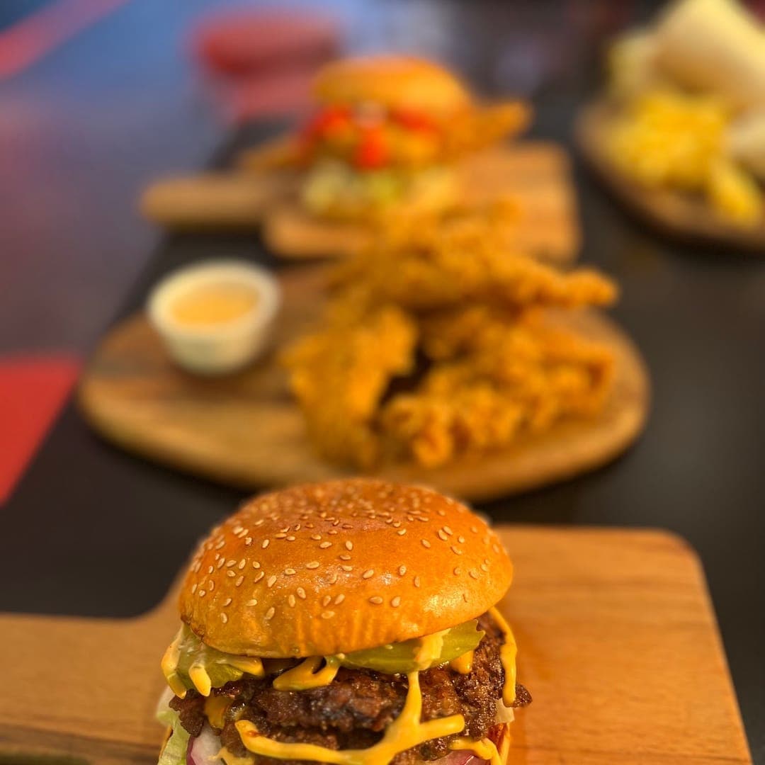 Route 66 — smash burger and fried chicken burger on wooden serving boards
