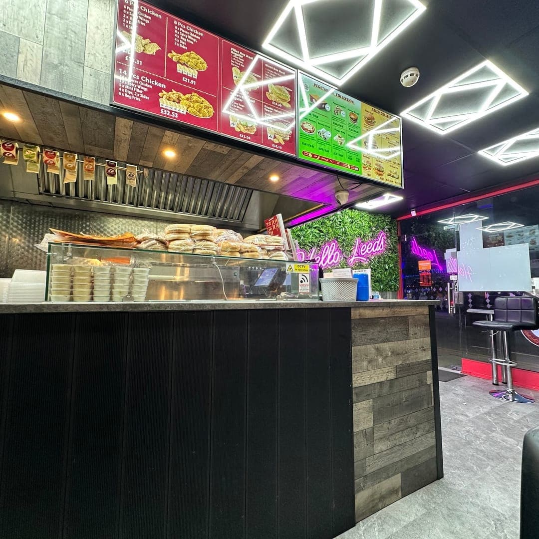 Route 66 — counter and dining area with neon signs and geometric ceiling lights