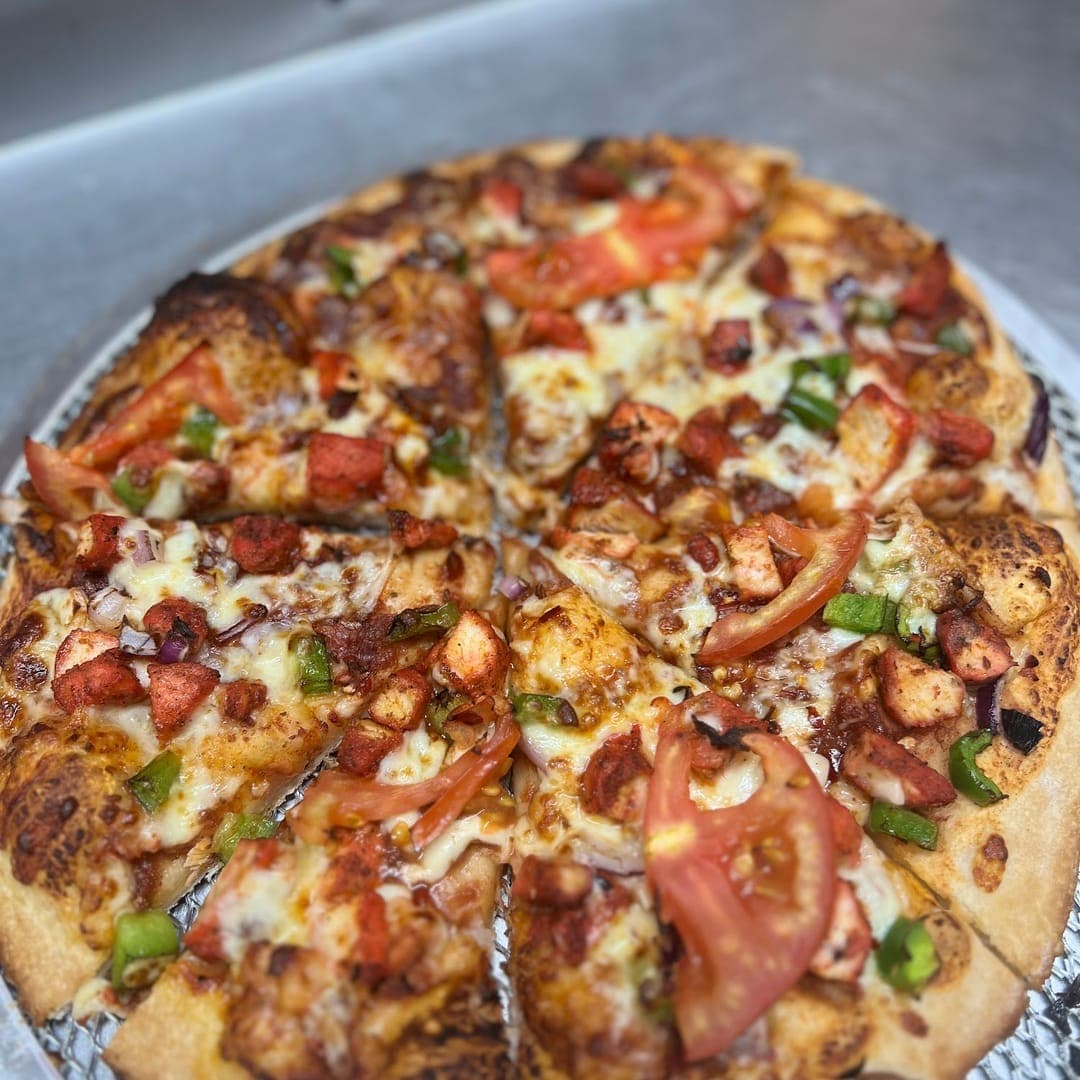 Route 66 — loaded pizza with chicken, tomato, peppers and melted cheese