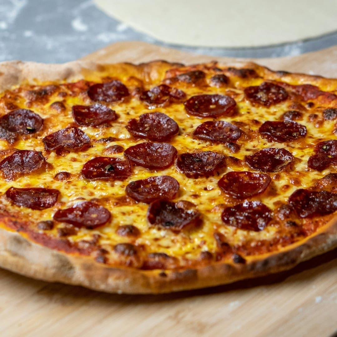 Secret Sky — pepperoni pizza on a wooden paddle