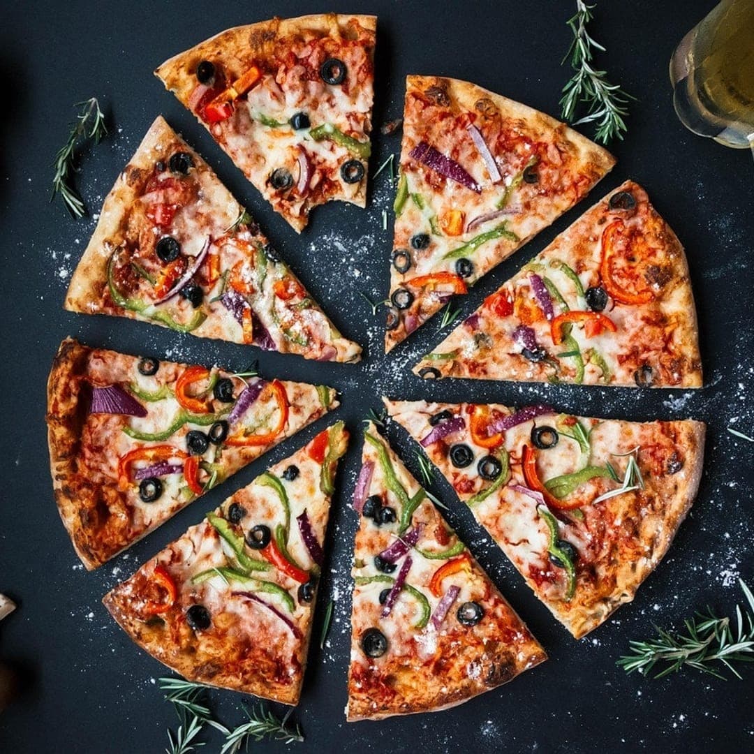 Secret Sky — sliced pizza with a glass of beer and fresh herbs