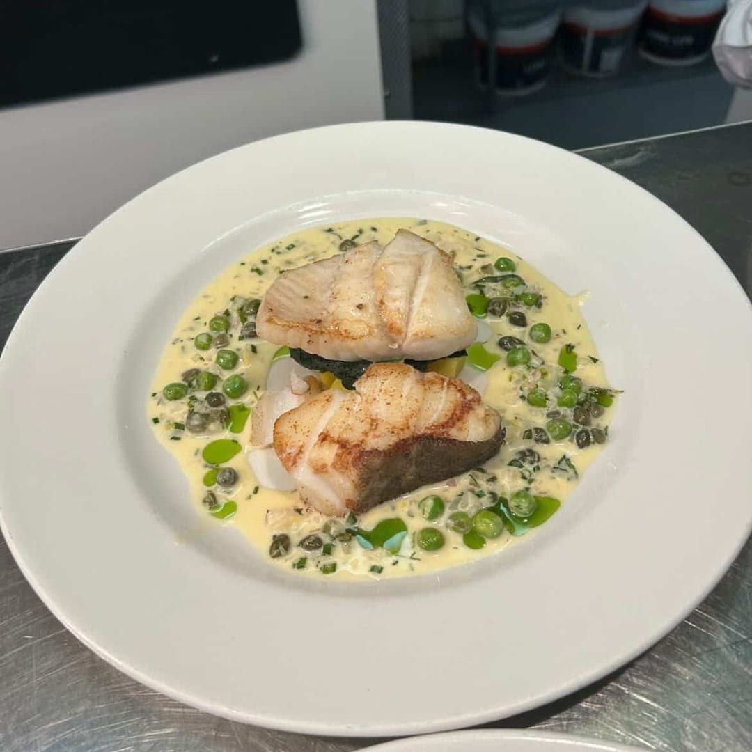 Pan-seared white fish with peas, capers and butter sauce at Sous Le Nez