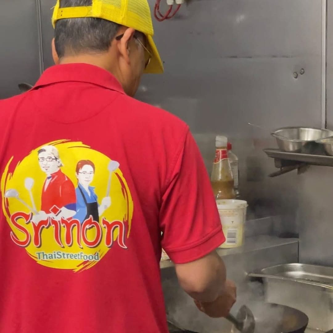 Head chef cooking at the wok in the Sri Non Thai Street Food kitchen