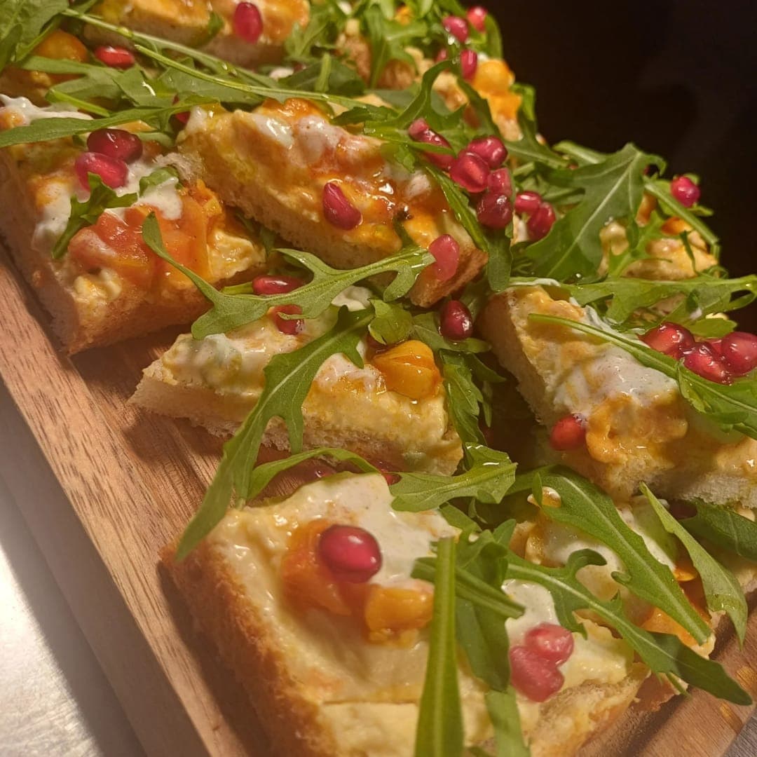 Tapas & Tunes — tapas board with sesame prawn toast, pomegranate seeds, and rocket salad