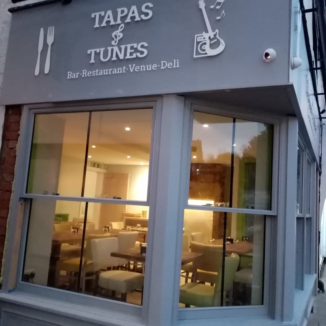 Tapas & Tunes — shopfront on Mercury Row, Otley, at dusk