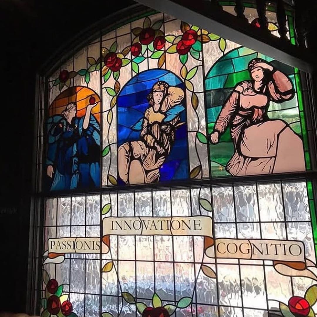 The Bankers Cat stained glass window with Pre-Raphaelite allegorical figures in jewel tones