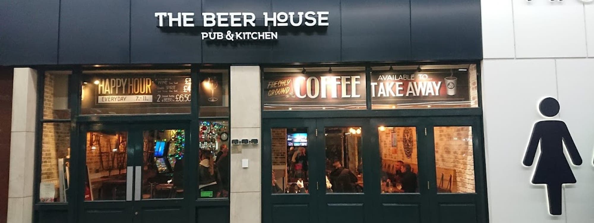 The Beer House Pub & Kitchen exterior at night, Leeds Train Station concourse