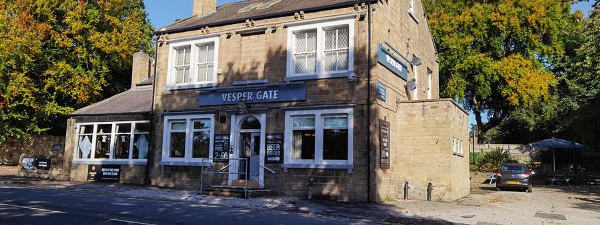 Vesper Gate — exterior view of the stone pub building with Vesper Gate signage