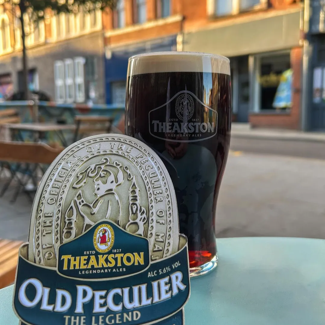Theakston Old Peculier pint with Kirkgate street view at Wapentake Leeds