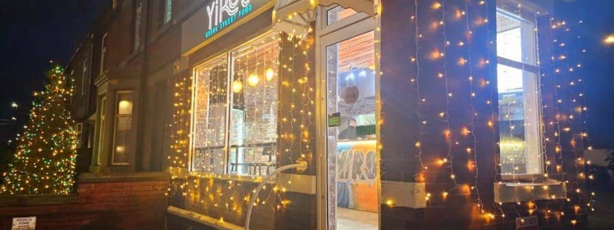 Yiros Greek Street Food shopfront on Aberford Road, Woodlesford, decorated with warm fairy lights at night