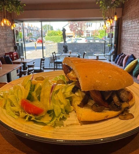 96 location Cafe — filled baguette with mushrooms and side salad