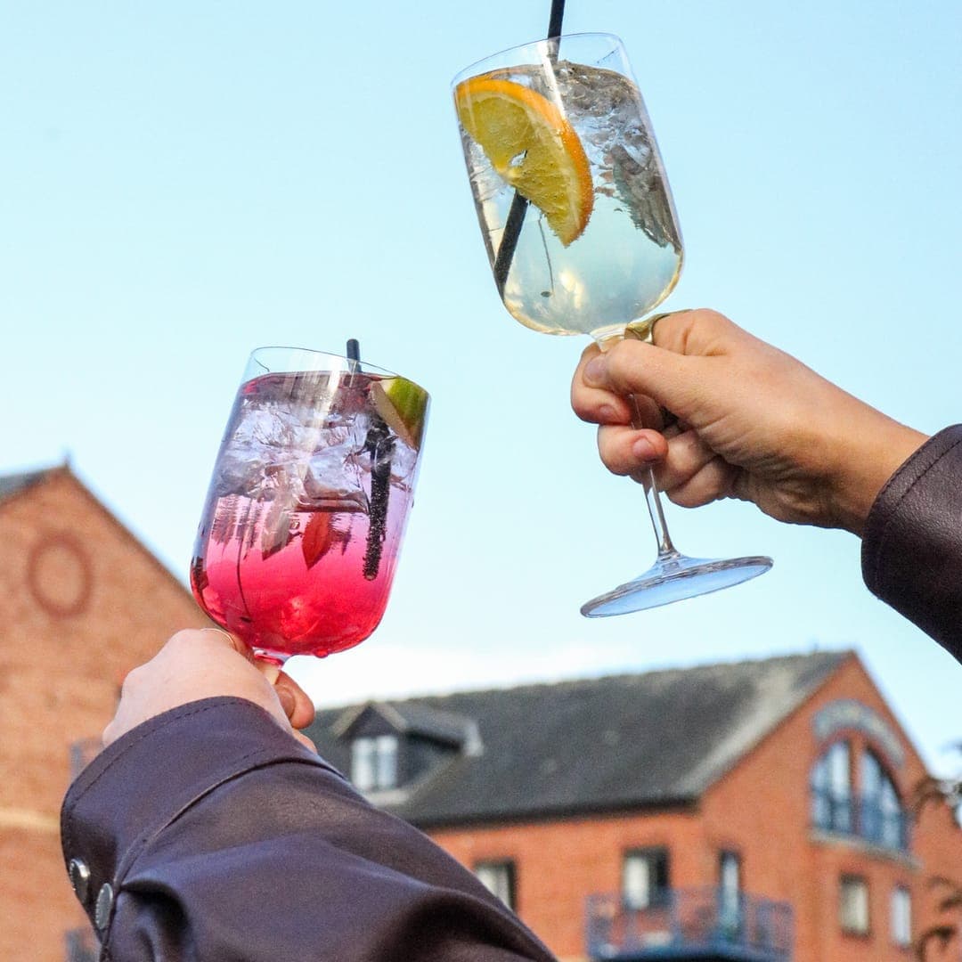 A cocktail drink served at Brewery Wharf Tavern with garnish against a colourful background