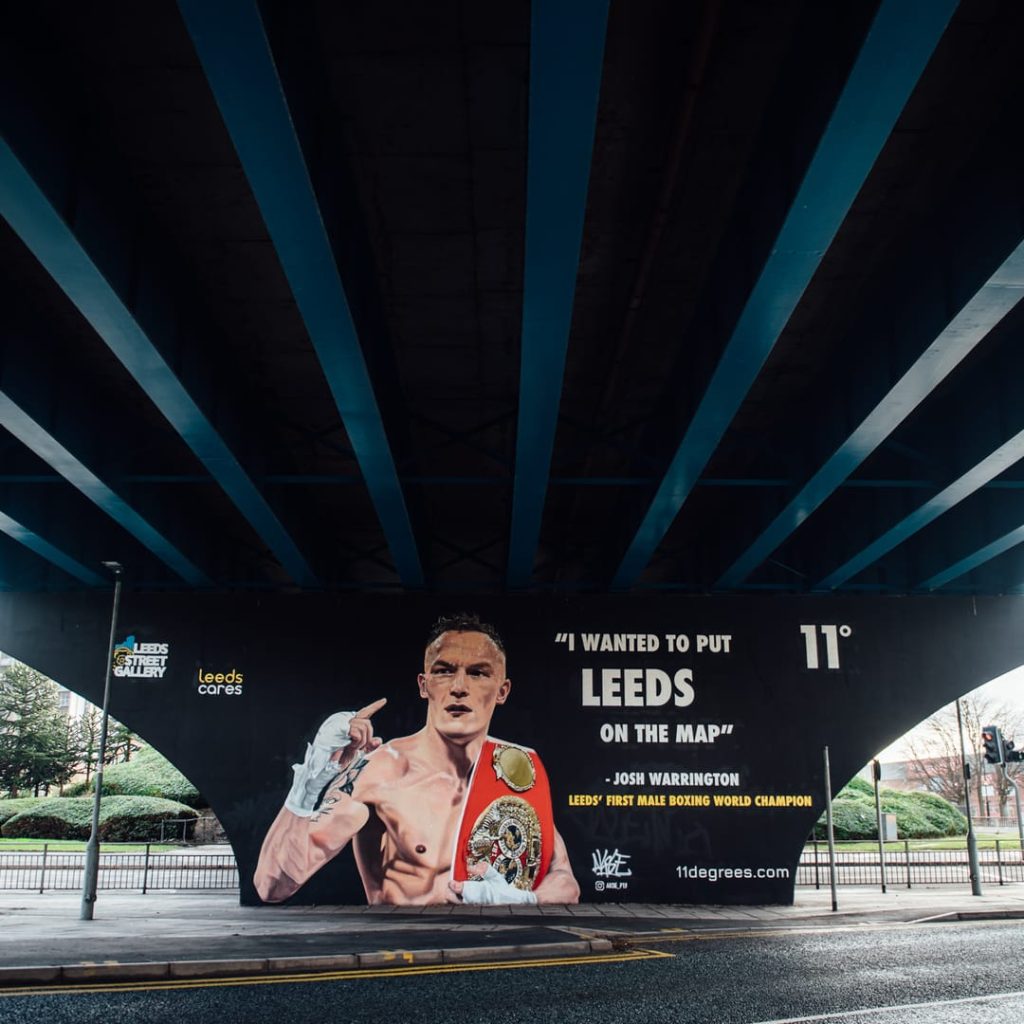 Josh Warrington mural by Akse P19 under the Inner Ring Road flyover on Wellington Street, Leeds — IBF World Featherweight champion tribute