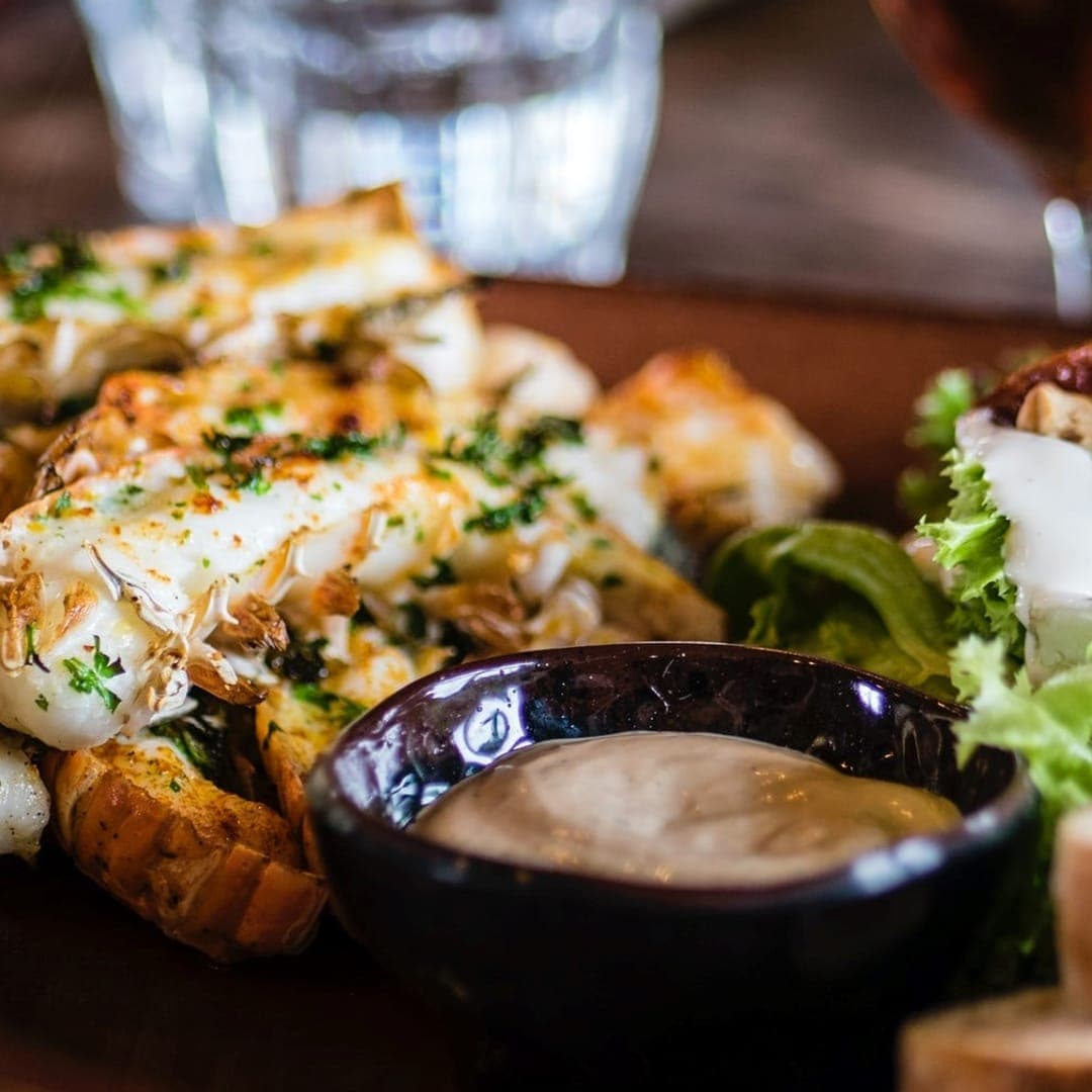 Grilled seafood bruschetta with side salad and dipping sauce at Miracle cafe