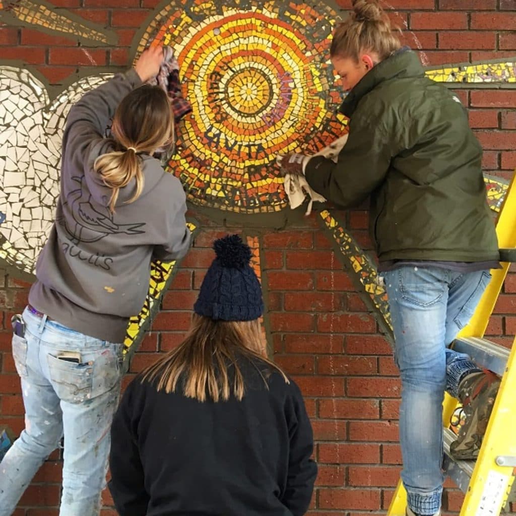 Rainbow of Hope mosaic at Kirkgate Market, Leeds — community mosaic by Mary Goodwin and Seagulls Reuse showing a rainbow, clouds and a Yorkshire rose