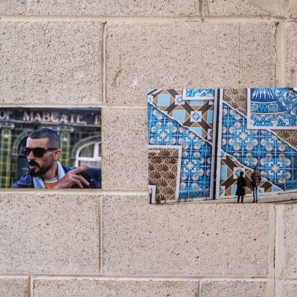 To Be Or Not To Be mural by Palestinian artist Taqi Spateen on Convention House, Mabgate, Leeds — two children with daisy imagery