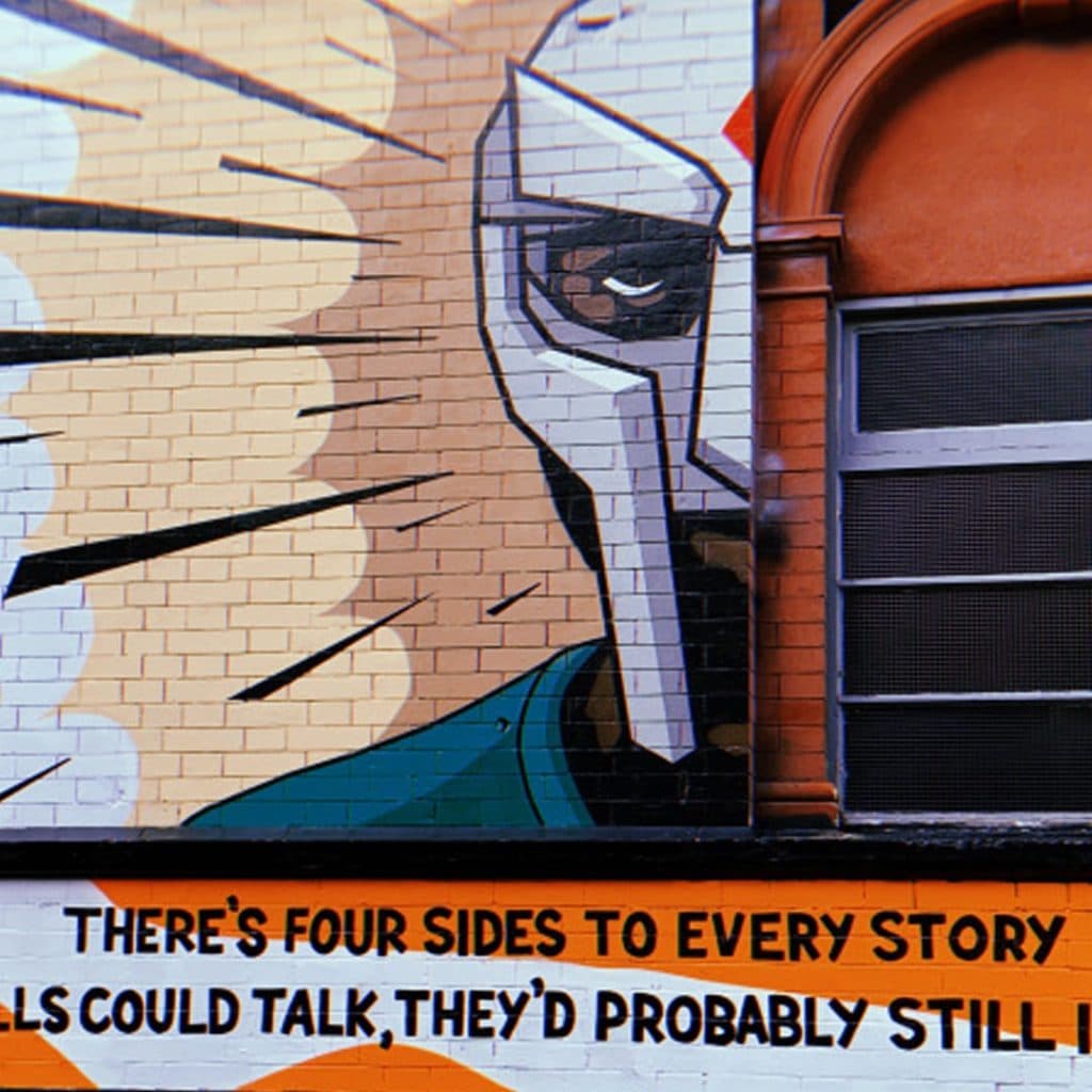 MF DOOM tribute mural by Two Times on the side wall of Belgrave Music Hall, Merrion Place, Leeds — masked profile of the rapper with lyrics