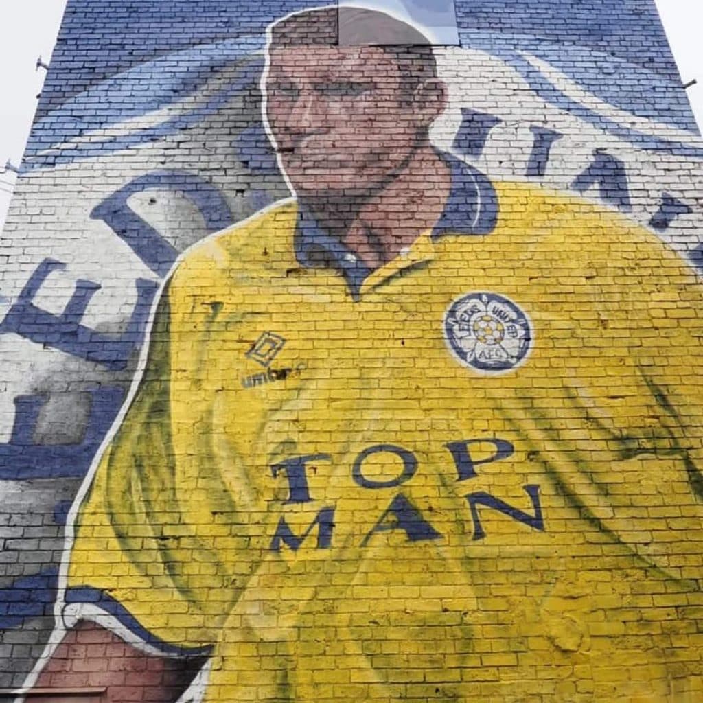 Vinnie Jones mural by Tom Crowe (Northern Mural Co) on the Foster Enterprises building, Whingate, Armley — Vinnie Jones in the 1989-90 yellow Top Man Leeds away kit