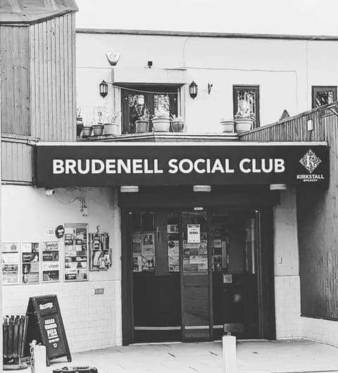 Black and white exterior of Brudenell Social Club Leeds showing the venue's prominent entrance sign and doorway