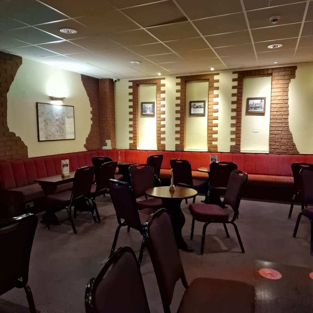 Lounge seating area at Brudenell Social Club Leeds with red banquette and traditional working men's club decor