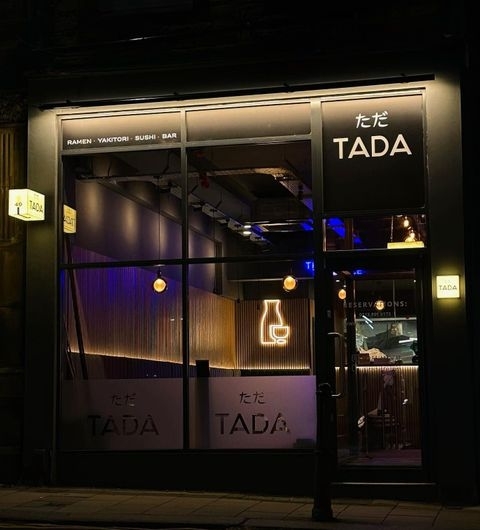TADA Modern Japanese Restaurant Night Facade Exterior night view of TADA restaurant with illuminated signage, showcasing ramen, yakitori, sushi, and bar offerings.
