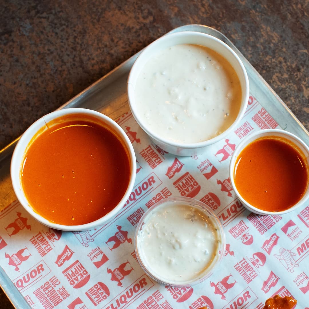 MEATliquor_Sauces_Tray_Variety_Dining Variety of sauces in small bowls on a tray at MEATliquor restaurant.
