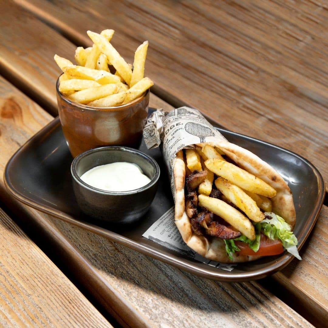 Residence Bar Cafe Kitchen Headingley Gourmet Gyro Fries Sauce Gyro with fries and dipping sauce served on a plate at Residence Bar Cafe | Kitchen (Headingley).