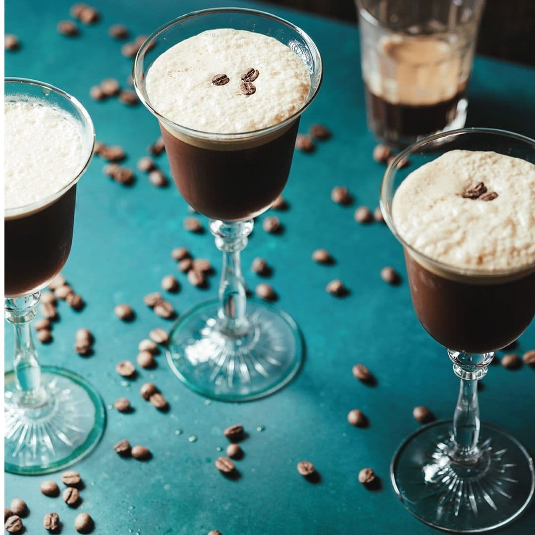 Blind Tyger Espresso Martinis Coffee Beans Espresso martinis served at Blind Tyger on a turquoise surface scattered with coffee beans.