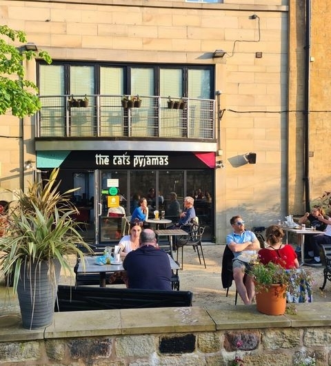 The Cats Pyjamas Chapel Allerton Sunny Outdoor Seating Outdoor seating at The Cat's Pyjamas – Chapel Allerton with patrons enjoying sunny weather.