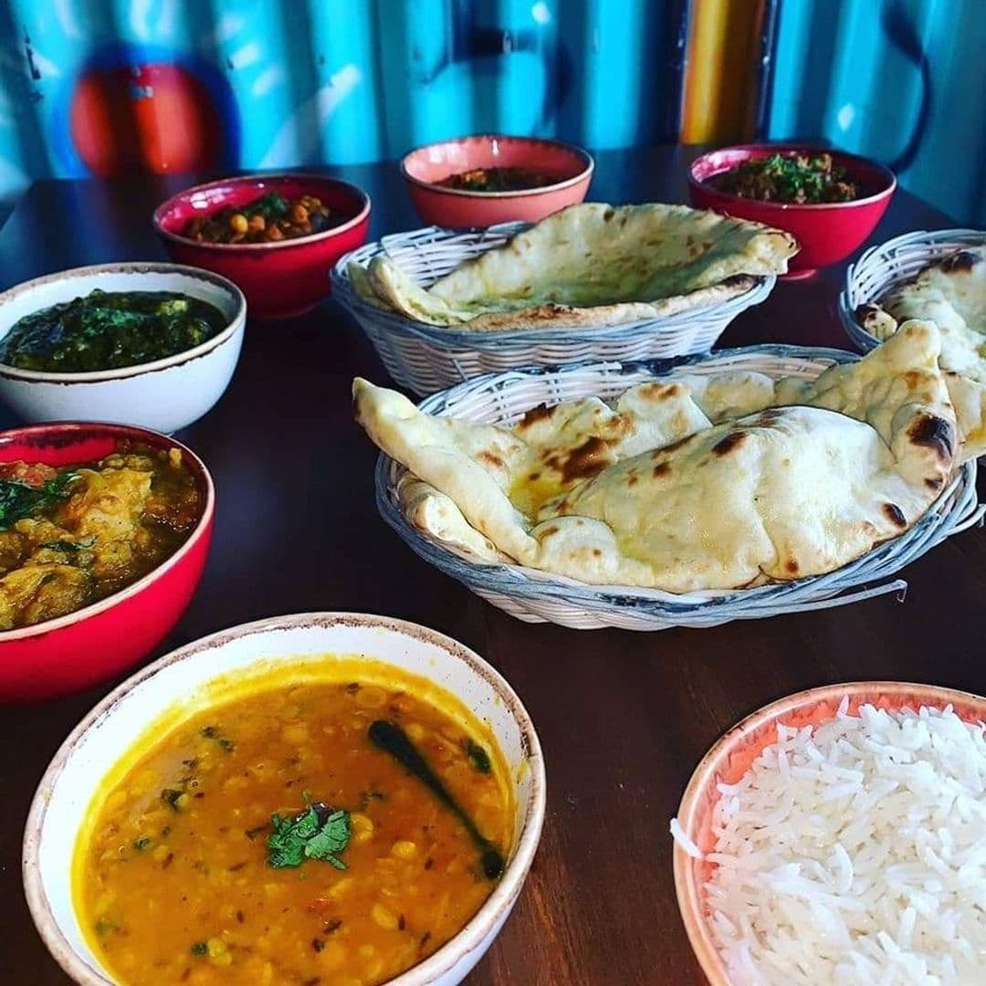 The Cats Pyjamas Farsley Indian Cuisine Dining Experience Assorted Indian dishes including naan bread, curry, rice, and lentils served at The Cat’s Pyjamas – Farsley.