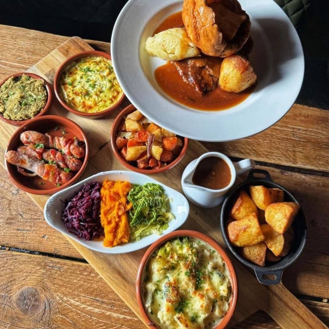 Traditional British Sunday roast and assorted sides served at The Thornhill, featuring Yorkshire pudding, roasted meats, and various vegetable dishes.