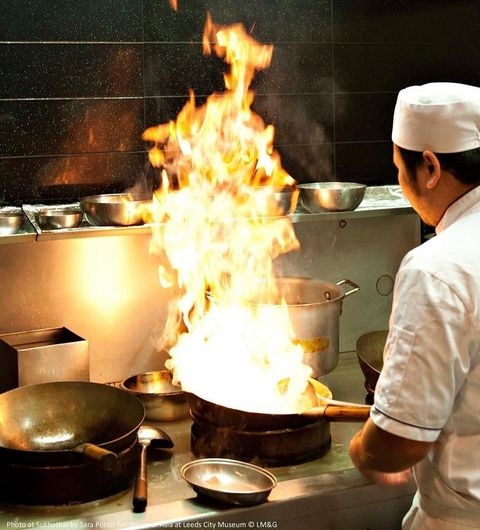Sukhothai Restaurant City Centre Chef Cooking Flame Wok Chef cooking with a large flame in a wok at Sukhothai Restaurant – City Centre.