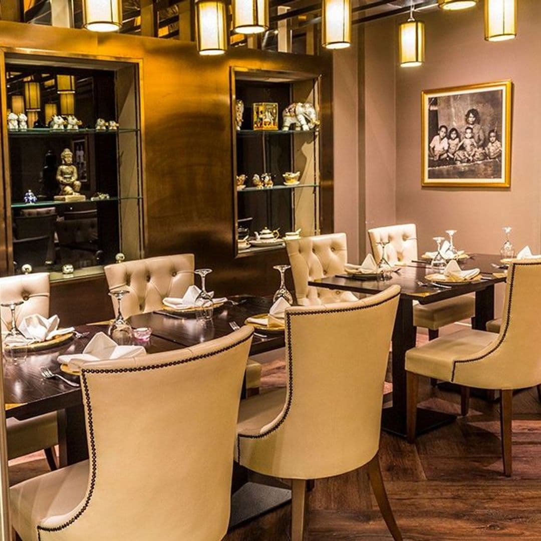 Sukhothai Restaurant City Centre Elegant Dining Interior Decor Elegant dining setup at Sukhothai Restaurant – City Centre, featuring cream upholstered chairs, dark wood tables, and warm ambient lighting.