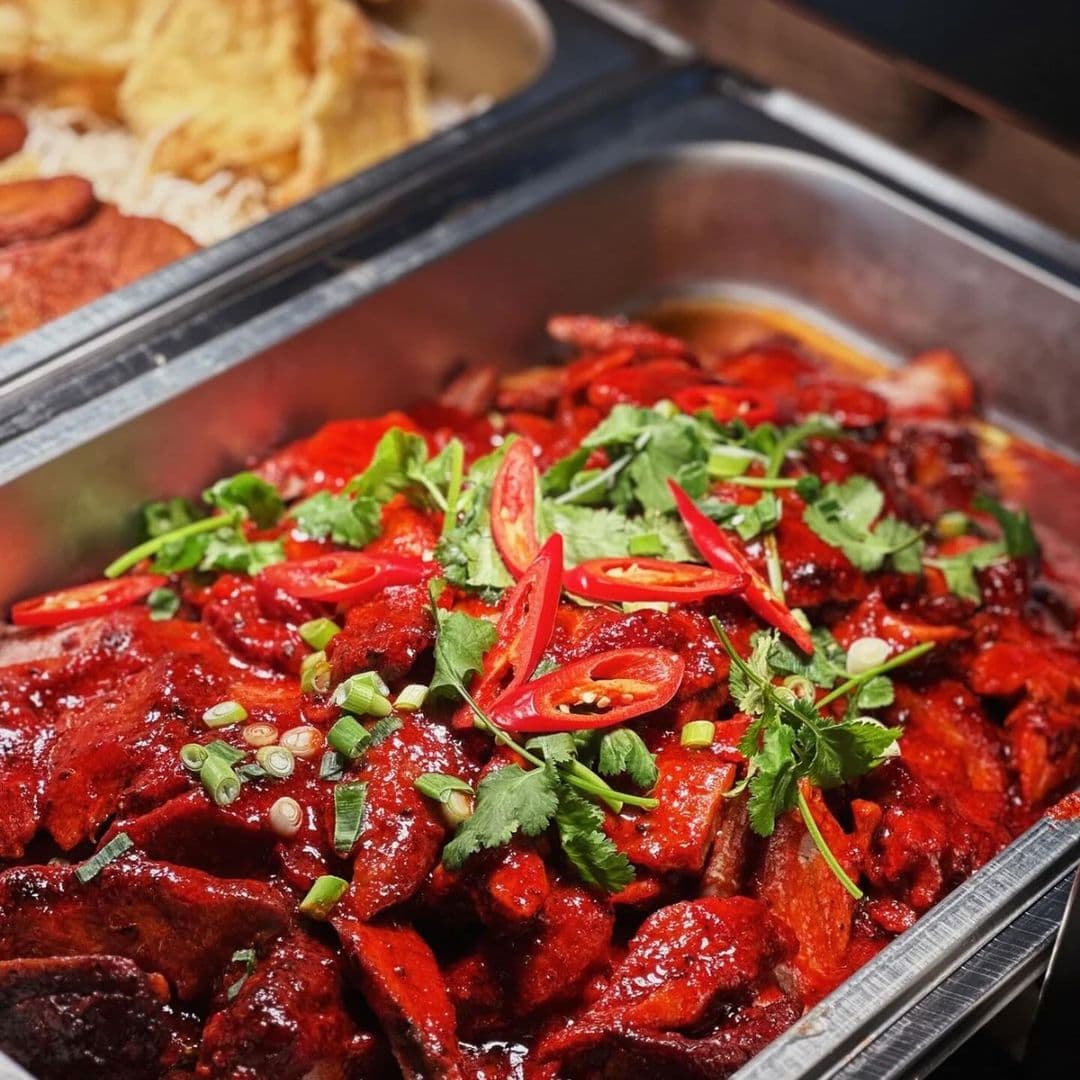 Sukhothai Restaurant City Centre Spicy Red Curry Chicken Dish "Delicious Thai red curry with tender slices of meat garnished with fresh red chilies and cilantro at Sukhothai Restaurant – City Centre."