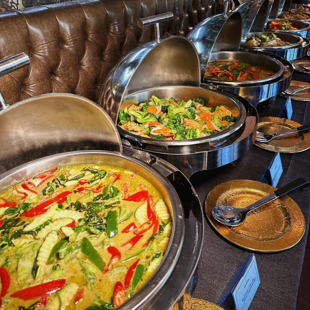 Sukhothai Restaurant City Centre Thai Buffet Spread Delicious Cuisine Buffet selection at Sukhothai Restaurant – City Centre, featuring a variety of Thai dishes in metal serving containers with lids, including green curry and stir-fried vegetables.